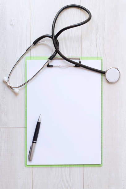 istock Blank medical clipboard with stethoscope on wood background. 1271491134