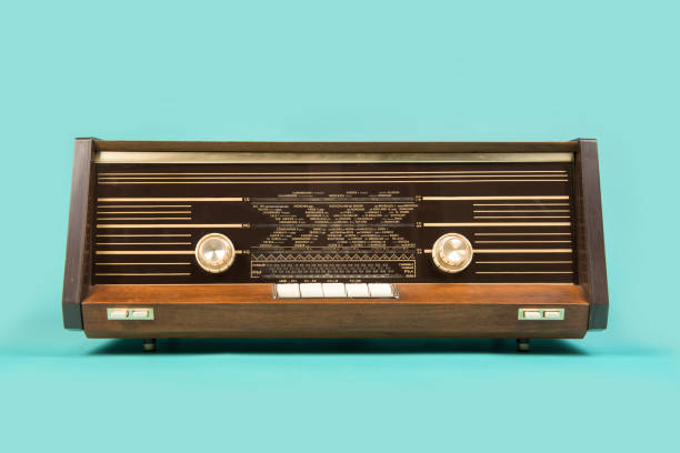 antique retro radio seen from the front on a turquoise blue background - radio old fashioned antique yellow imagens e fotografias de stock