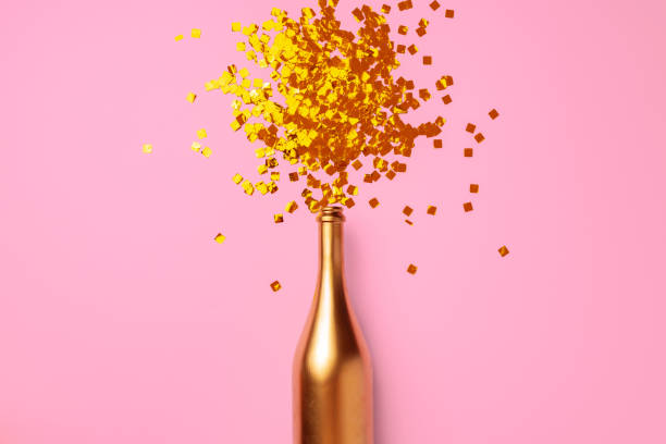 istock Champagne bottle with confetti flat lay top view 1271492530