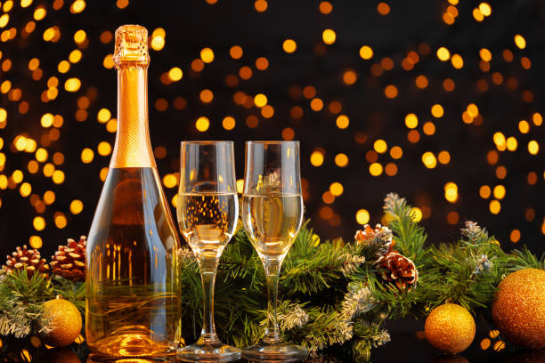 istock Champagne bottle and glasses on blurred lights background 1271492654