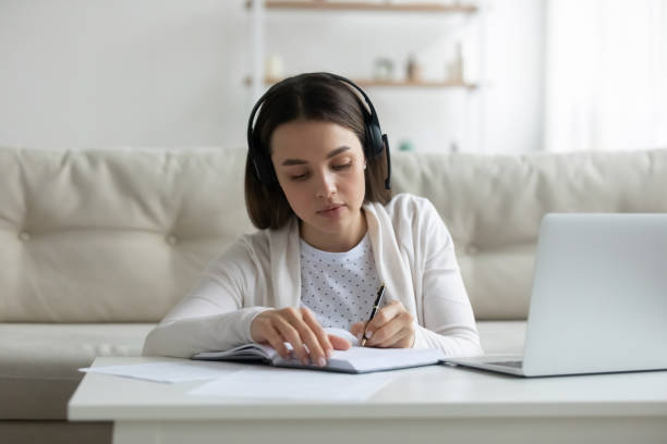 istock Serious young woman listening online lecture on computer. 1271492893