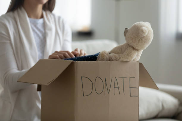 Kind volunteer put things for poor families in charity package.