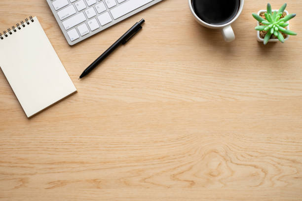 istock Wooden office desk table with keyboard, notebook and coffee cup with equipment other office supplies. Business and finance concept. Workplace, Flat lay with blank copy space. Top view 1271494501