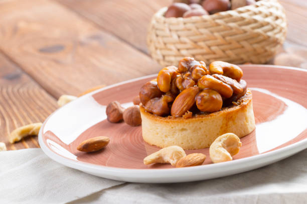 istock Tart with nuts on pink plate close up 1271494536