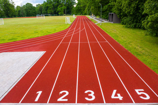 istock perspective view of an open - air stadium with red numbered running tracks 1271496005