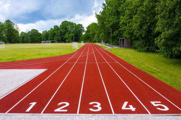 istock perspective view of an open - air stadium with red numbered running tracks 1271496053
