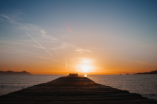 Sunrise with wooden jetty by the sea for silhouette concepts in Majorca