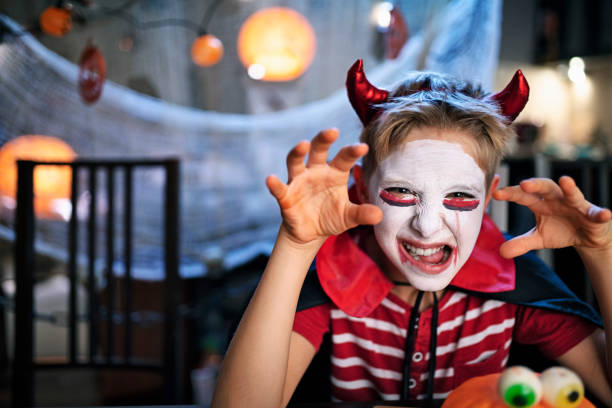 istock Little boy making scary face at Halloween party 1271499005