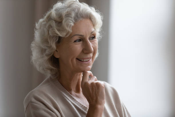 istock Close up smiling dreamy mature woman thinking about good future 1271502085