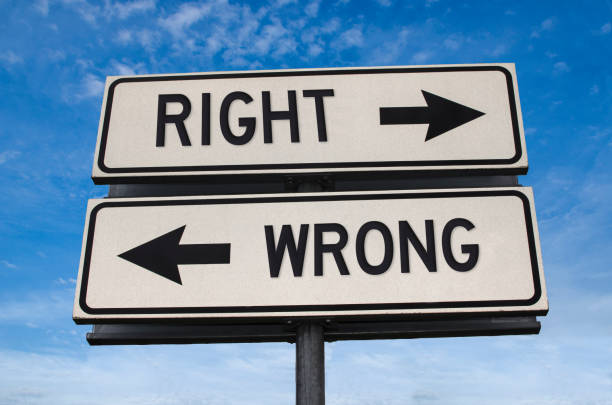 right vs wrong. white two street signs with arrow on metal pole with word. directional road. crossroads road sign, two arrow. blue sky background. two way road sign with text. - solution road sign guidance sign imagens e fotografias de stock