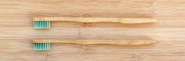 istock Set of two bamboo toothbrushes on wood panoramic background. Zero waste, plastic free, environment concept web banner 1271503735