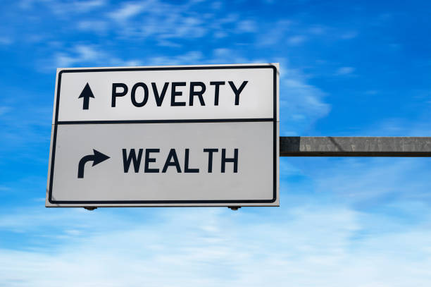 istock Poverty versus wealth white arrow road sign on blue sky background. 1271505758
