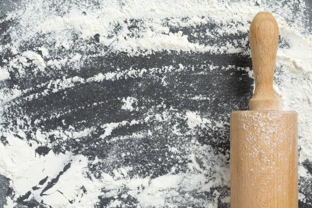 istock Close up of rolling pin on wheat flour background 1271506426
