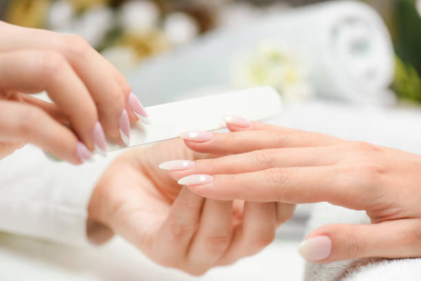 istock Manicure nail paint with thin brush on colour background, 1271506752