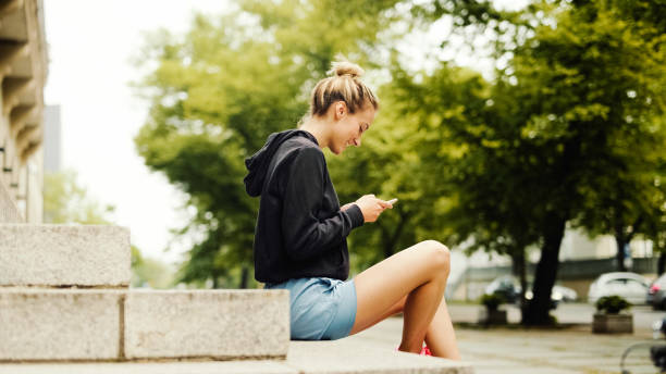 istock Young attractive woman using phone in city. 1271508363