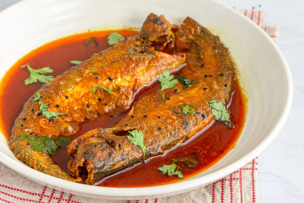 istock Traditional Indian Small Fish Curry with Gravy in a Serving Bowl Garnished with Cilantro 1271508899