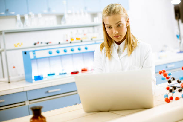 istock Female researcher in white lab coat using laptop while working in the laboratory 1271509758