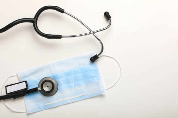 istock Corona virus outbreaking, Phonendoscope and Mask on white background 1271510808