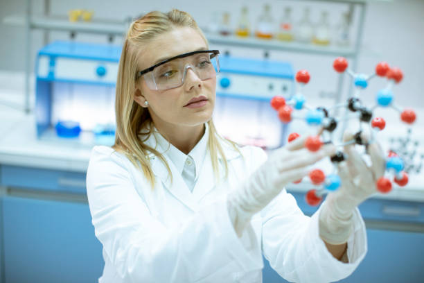 istock Female chemist hold molecular model in the lab 1271511353