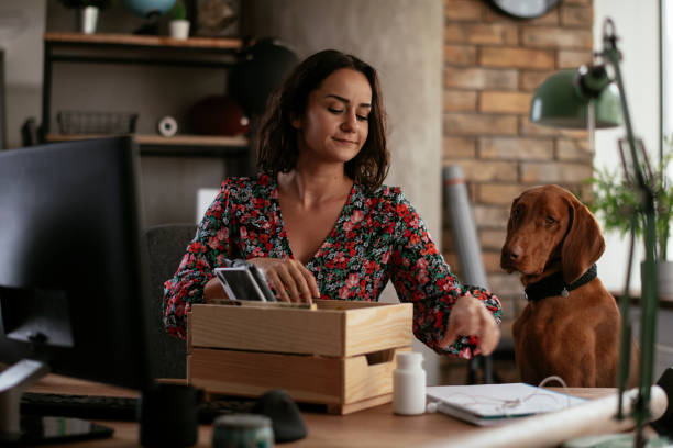 istock Young businesswoman in office organizing documents. 1271511408