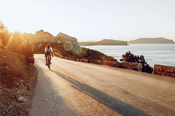 istock Cyclist riding on his bicycle at coastal road 1271512058