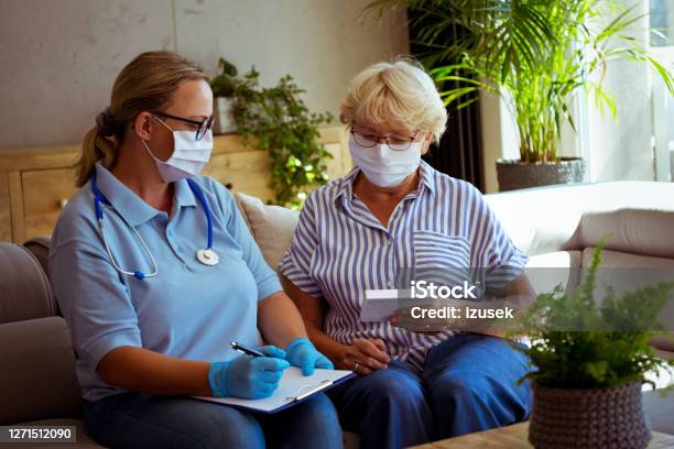 Home Nurse Visiting Senior Woman During Coronawirus Pandemic Stock Photo - Download Image Now