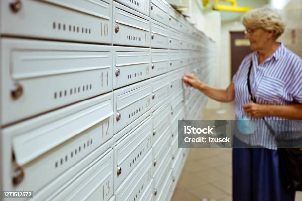 Senior Woman Checking For Mailbox Stock Photo - Download Image Now - Box - Container, Envelope, Mailbox