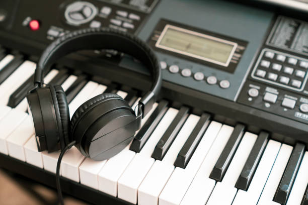 istock Headphones on musical synthesizer keyboard 1271513783