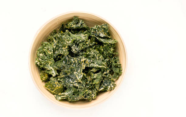 istock Kale chips in a bowl on a white background. View from above 1271515031