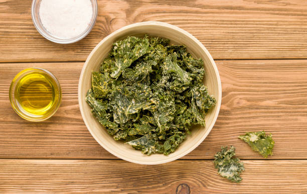 istock Kale chips on a wooden table. View from above. Rustic 1271515078