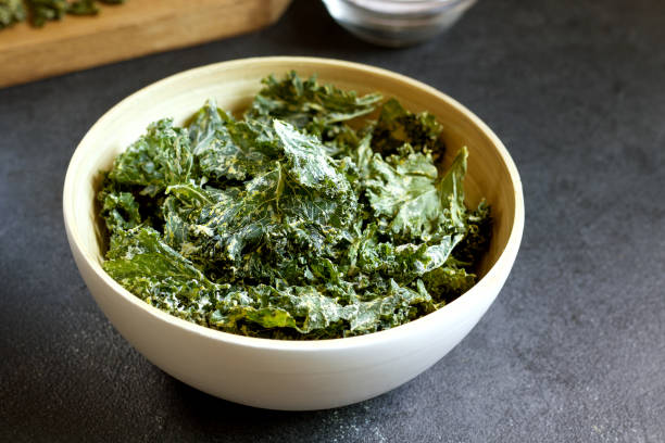 istock kale chips in bowl on black background 1271515095