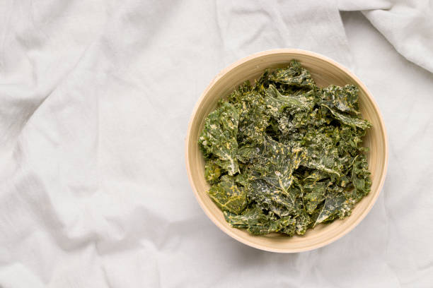 istock Kale chips in a bowl on a gray background. View from above. Copy space 1271515130