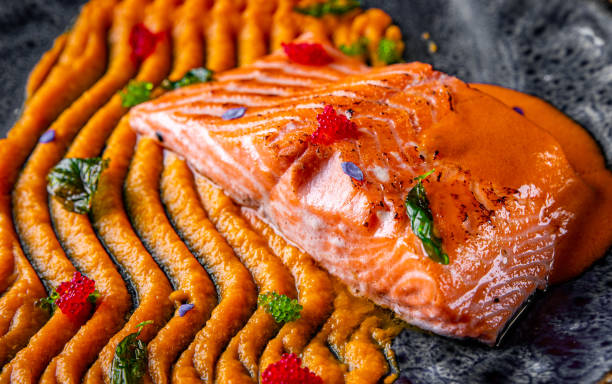 istock Roasted salmon steak with pumpkin cream on plate 1271515558
