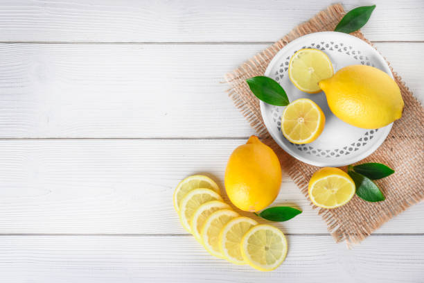istock Fresh juicy lemons on white rustic table. 1271515779