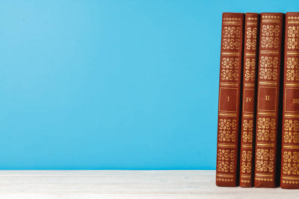 istock Stacked books on wooden desk front view 1271515929