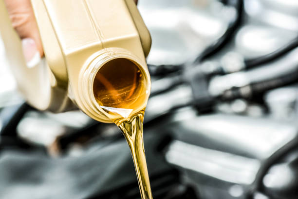 istock Pour yellow motor oil into car engine. 1271515942