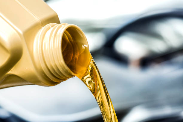 istock Pour yellow motor oil into car engine. 1271515984