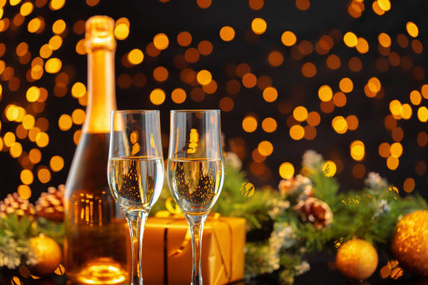 istock Champagne bottle and glasses on blurred lights background 1271517053