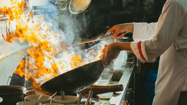 istock Chef stir fry busy cooking 1271518589