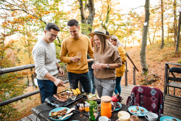 istock Cheerful man chit chatting with his friends while grilling meat and vegetable for their brunch 1271519894