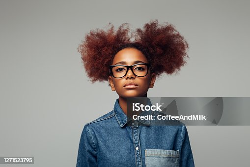 istock Photo of young curly girl with glasses 1271523795