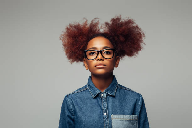 Photo of young curly girl with glasses Photo of young curly girl with glasses serious black teen stock pictures, royalty-free photos & images