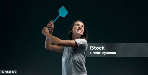 Angry Woman Killing Mosquitoes With A Fly Swatter Stock Photo - Download Image Now - Mosquito, Fly Swatter, Insect