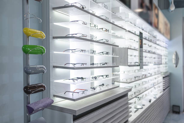 row of stylish glasses at an opticians. side view photo Glasses on the shelf. Ophthalmology room.  Inside Interior of an Optometrist optical instrument stock pictures, royalty-free photos & images