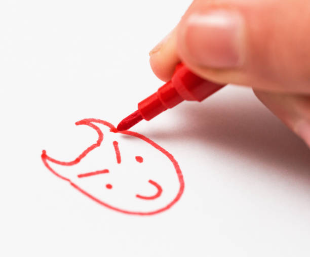 istock Child's hand drawing a picture of a cartoon devil 1271525735