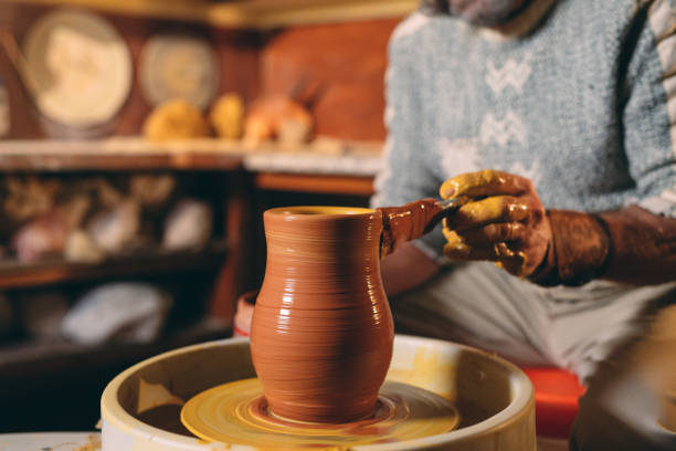 istock Pottery workshop. A senior man makes a vase of clay. Clay modeling 1271525989