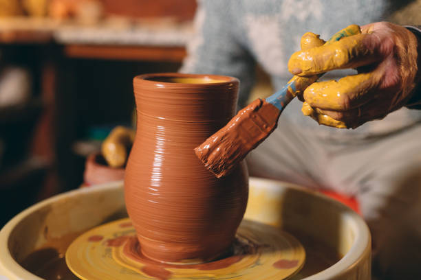 istock Pottery workshop. A senior man makes a vase of clay. Clay modeling 1271525999