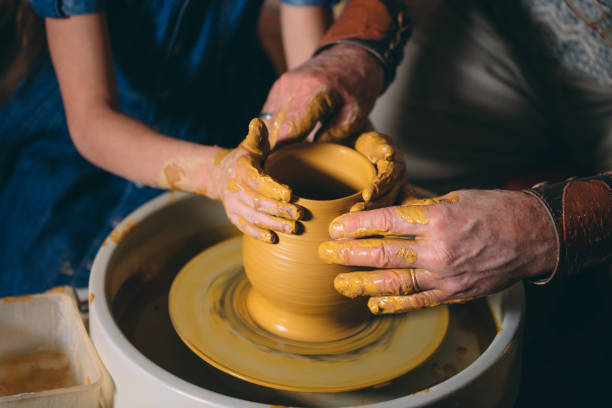 istock Pottery workshop. Grandpa teaches granddaughter pottery. Clay modeling 1271526203