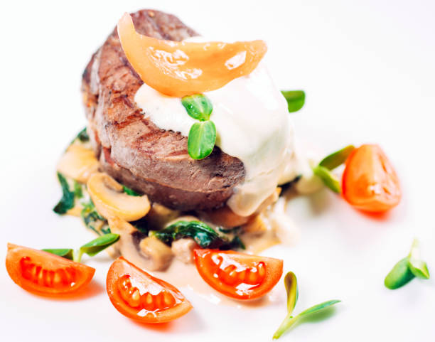 istock Veal medallions with spinach on the white plate 1271526221