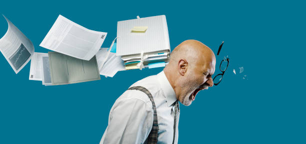 istock Paperwork hitting a businessman's head 1271526285